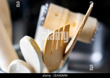 close-up view of a group of wooden kitchen utensils. Selective focus on the fork. Stock Photo
