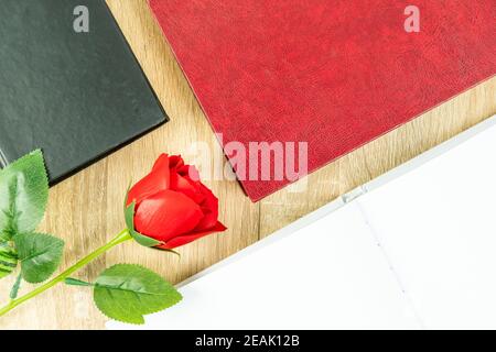 Red roses and empty blank notebook diary and eye glasses with hardcover book Stock Photo