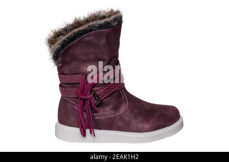 Winter shoes isolated. Close-up of a single elegant violet suede leather winter boots and lined with brown fur. Girls winter shoe fashion new trends isolated on a white background. Macro photograph. Stock Photo