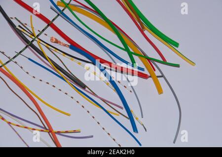 copper and aluminum power electrical wires of different colors on the white background Stock Photo