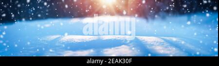 Winter snowy background with sparkling snow at sunny day in snowfall Stock Photo