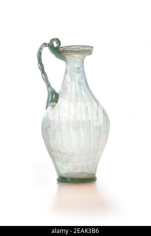 Ancient Roman jug with chain handle. Natural-coloured Glass of the 1st and 2nd centuries AD. Clipping path for design purposes. Stock Photo