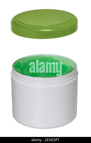 Closeup of a opened white plastic jar or container for cosmetic gel or cream with a green cap isolated on a white background. Empty space. Macro. Stock Photo