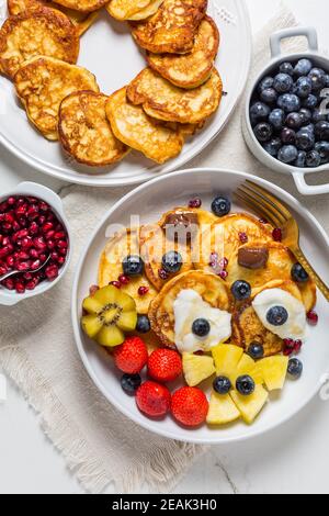 Homemade low calarie curd cheese pancakes with fruit salad Stock Photo