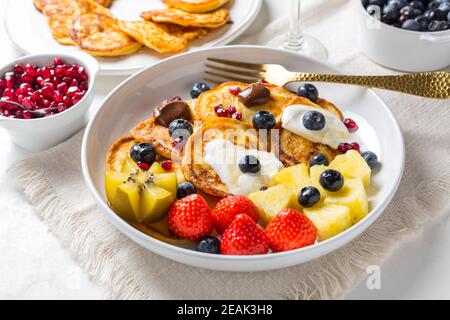 Homemade low calarie curd cheese pancakes with fruit salad Stock Photo