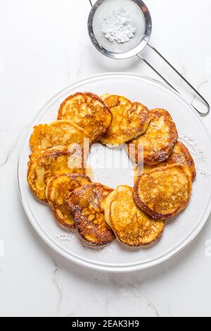 Homemade low calarie curd cheese pancakes on white plate Stock Photo