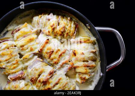 Croque Monsieur Hasselback Potatoes. Stock Photo