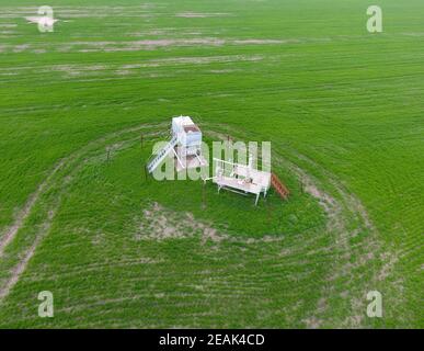 Equipment of an oil well. A tank with methanol near the oil well. Shutoff valves and service equipment Stock Photo