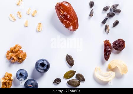 Seeds of sunflower, nuts, fruits and dried fruits on white background with copy space. Stock Photo