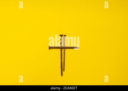 metal rusty nails on a yellow background Stock Photo