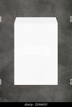Large A4 white enveloppe mockup template on dark concrete background Stock Photo