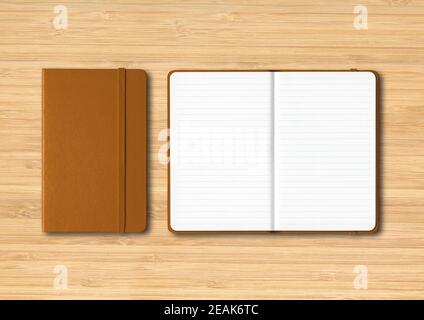 Leather closed and open lined notebooks on wooden background Stock Photo