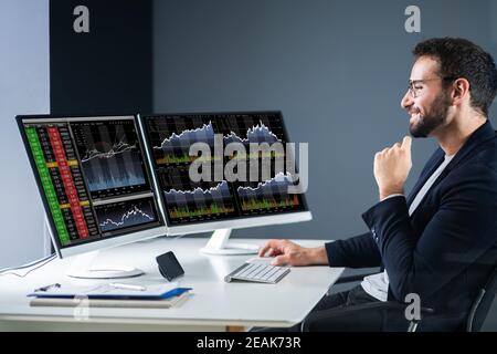 Stock Exchange Business Analyst Using Computer Stock Photo