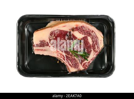 Close up raw beef ribeye steak vacuum sealed Stock Photo