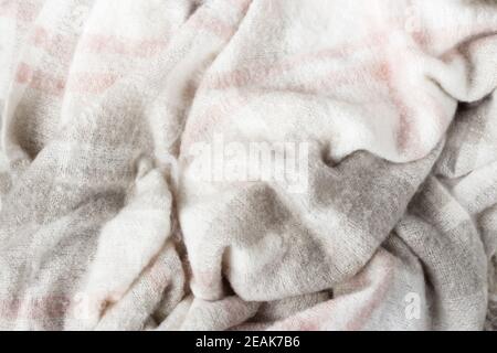 Crumpled gray wool blanket. Soft and warm fabric crumpled in folds. Texture Stock Photo