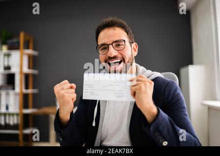 Holding Paycheck Or Payroll Check Or Insurance Cheque Stock Photo