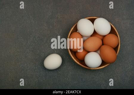 Bowl of brown and white chicken eggs on table Stock Photo