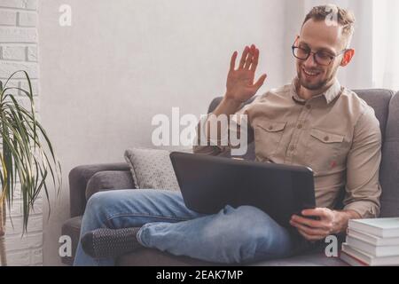 Video conferencing with relatives on laptop at home. Distance meeting and talking concept. Stock Photo