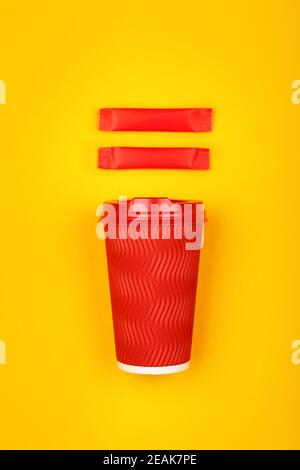 Red paper coffee cup over yellow Stock Photo