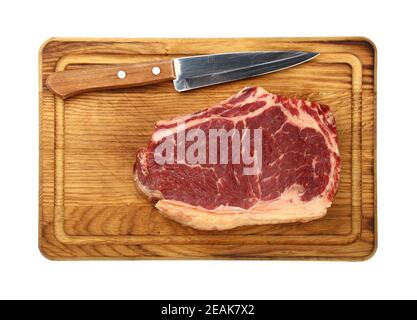 Close up raw beef ribeye steak on wooden board Stock Photo
