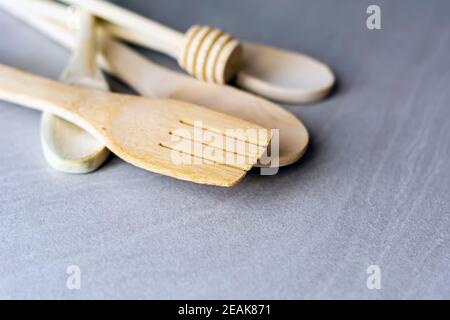 Group of wooden kitchen utensils arranged on a gray marble table Stock Photo