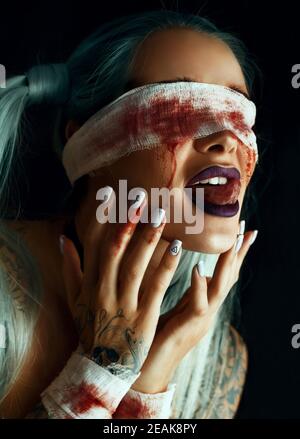 Artistic portrait of a girl with blood on her eyes  Stock Photo