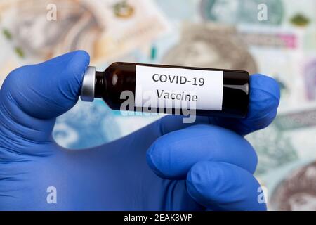 Vaccine against covid-19 on the background of Polish money Stock Photo