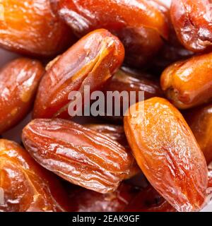 Background of big raw dried dates, situated arbitrarily. Stock Photo