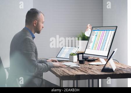 Analyst Employee Working With Spreadsheet Stock Photo