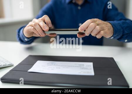 Remote Check Deposit Using Mobile Photo. Scanning Documents Stock Photo