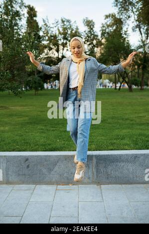 Beautiful arab female student poses in summer park Stock Photo