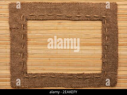 Frame of burlap, lies on a bamboo mat Stock Photo