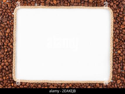 Frame made of rope with  coffee beans  lying on a white background Stock Photo