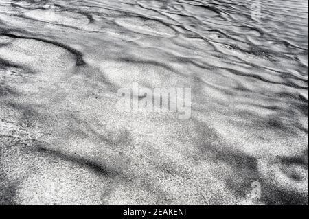 Abstract dirty black texture on white snow. Stock Photo