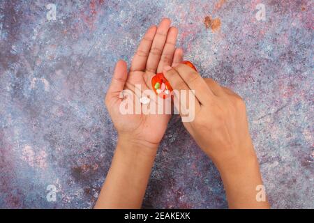 top view of women hand taking pills on table  Stock Photo