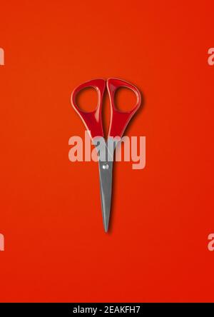 Pair of scissors isolated on red background Stock Photo