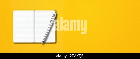 Yellow open notebook with a pen isolated on colorful background. Horizontal banner Stock Photo