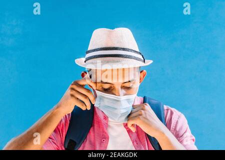 young man taking off his mask. Stock Photo