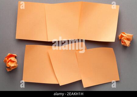 Orange Blank Paper Notes And Crumbled Paper Stock Photo