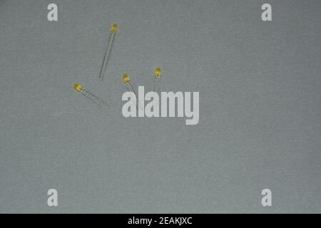 four yellow light emitting diode not connected on grey background Stock Photo