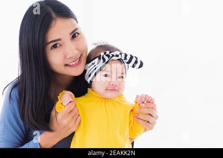 mother playing and smiling together with his newborn little baby Stock Photo