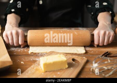 Women preparing homemade food pie, pizza, pasta with a dough roll. Hobbies and family life concept Stock Photo