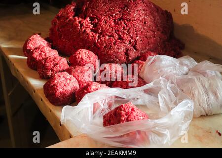 Piles of rounded ground meat ready for packaging Stock Photo