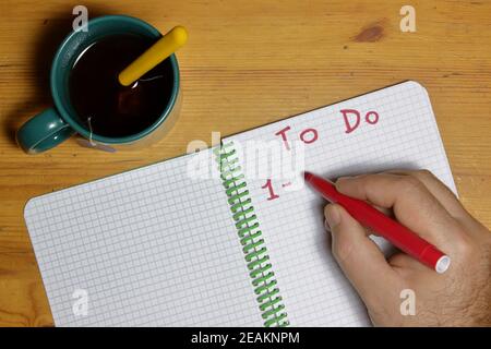 to do list with a man hand with red marker writing point one Stock Photo