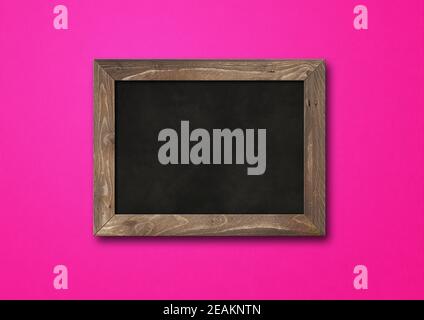 Old rustic black board isolated on a pink background Stock Photo