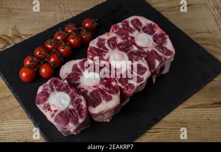 raw meat photographed on a wooden cutting board with a black background Stock Photo