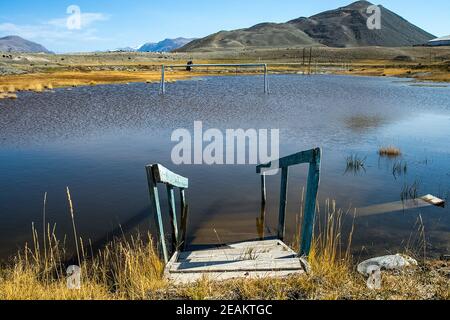 old broken pier on the shore of the lake. Altai. Stock Photo