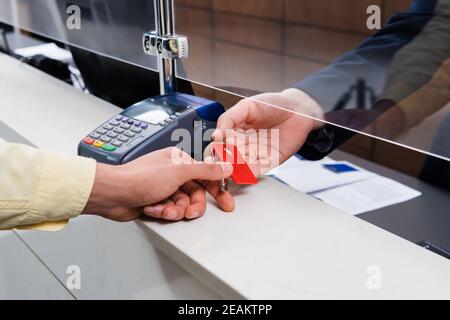 Cropped view of man taking key from hotel manager in lobby Stock Photo