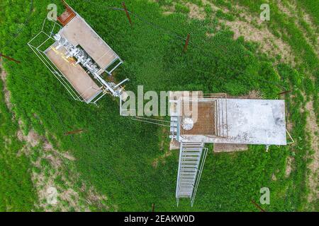 Equipment of an oil well. A tank with methanol near the oil well. Shutoff valves and service equipment Stock Photo