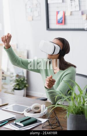 young african american architect gesturing in vr headset on blurred foreground Stock Photo